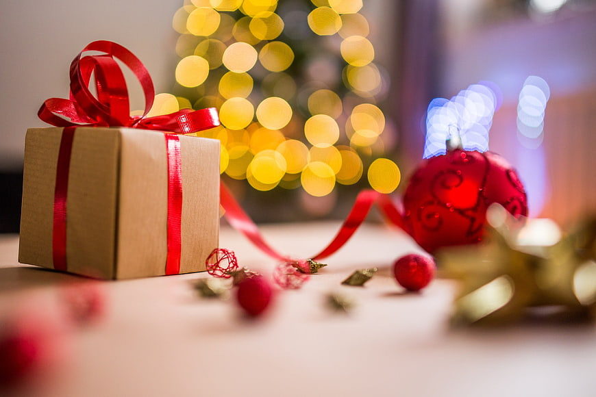 Christmas Gift Box with Red Ribbon and Bokeh Lights