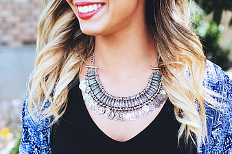 Close-up of Smiling Woman Wearing Silver Coin Necklace