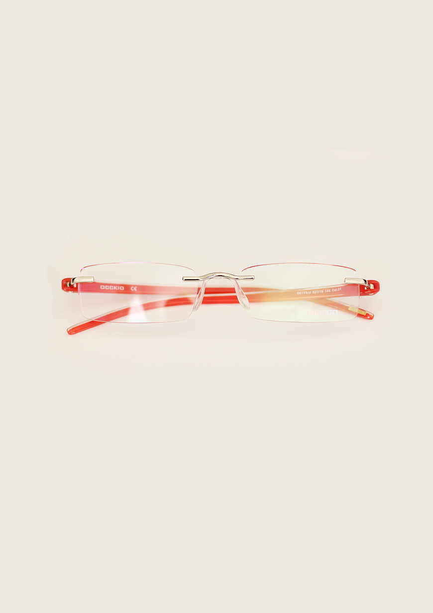Red Rimless Eyeglasses on White Background