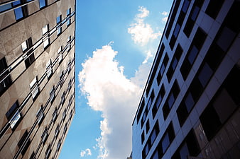 Low angle view of modern office buildings against blue sky
