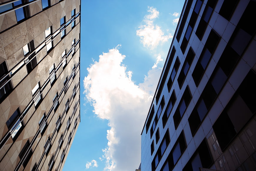 Low angle view of modern office buildings against blue sky