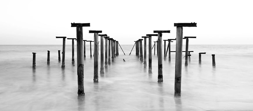 Black and White Long Exposure of Weathered Pier Pilings