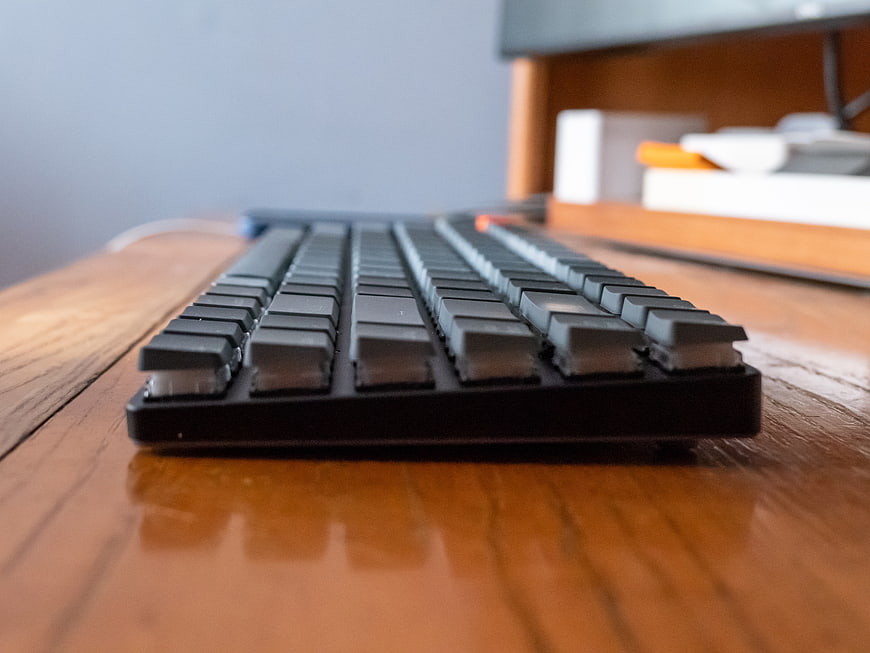 Close-up of black mechanical keyboard on wooden desk