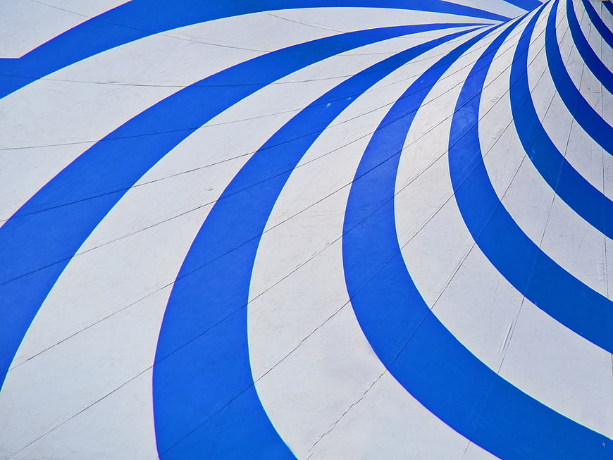 Abstract Blue and White Swirling Stripes Pattern Background