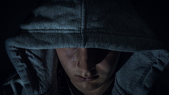 Mysterious Man In Hood With Dramatic Dark Lighting