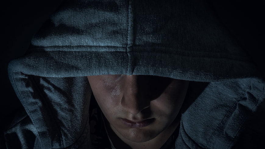 Mysterious Man In Hood With Dramatic Dark Lighting