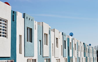 Modern Blue And White Townhouses Under Clear Sky