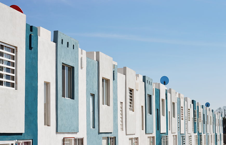 Modern Blue And White Townhouses Under Clear Sky