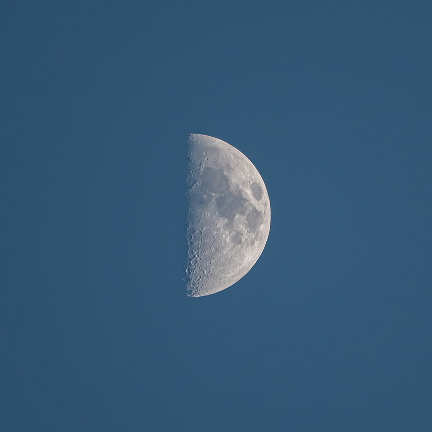 Crescent Moon in Blue Sky with Craters