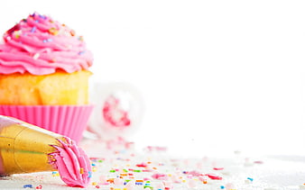 Pink Cupcake with Sprinkles and Piping Bag on White Background