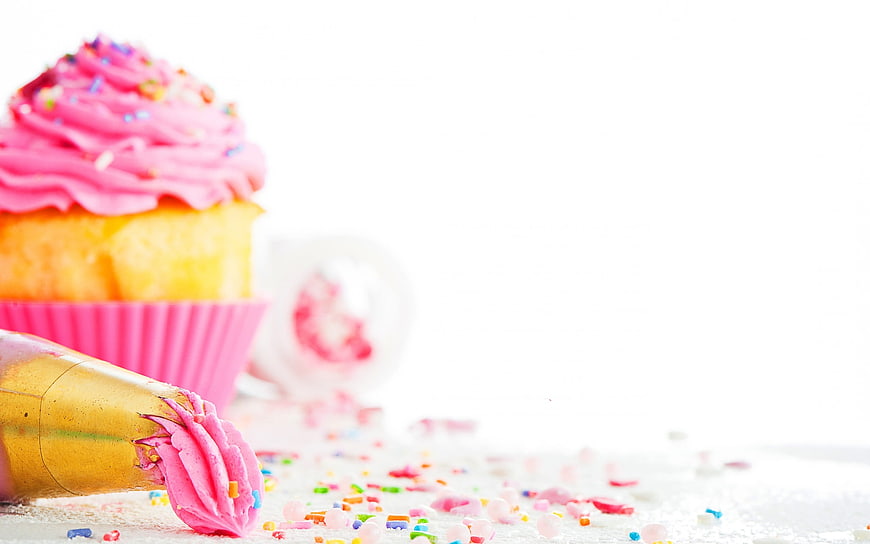 Pink Cupcake with Sprinkles and Piping Bag on White Background