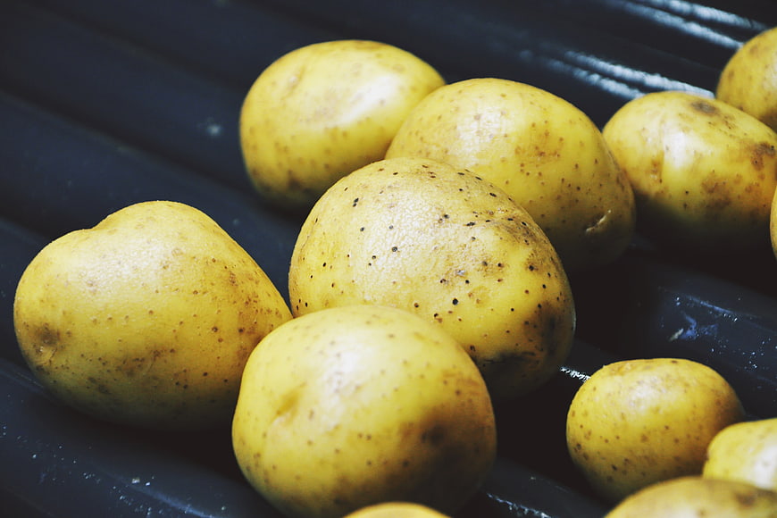 Fresh Yellow Potatoes in Black Tray