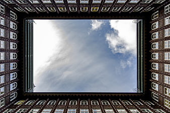Low angle view of historic brick building courtyard sky
