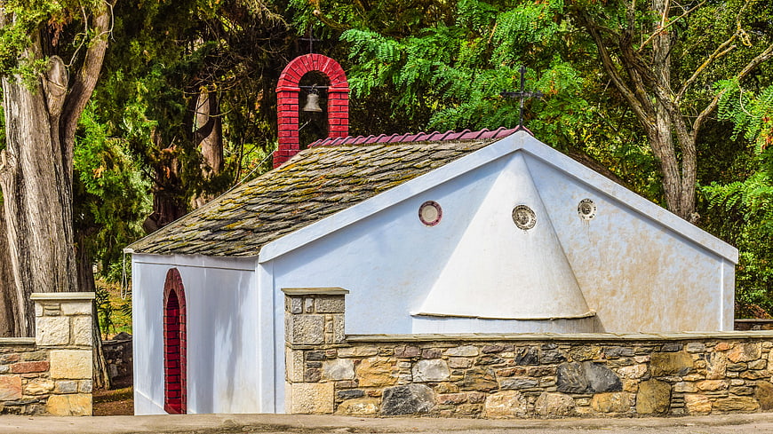 Small white Greek Orthodox chapel with red bell tower