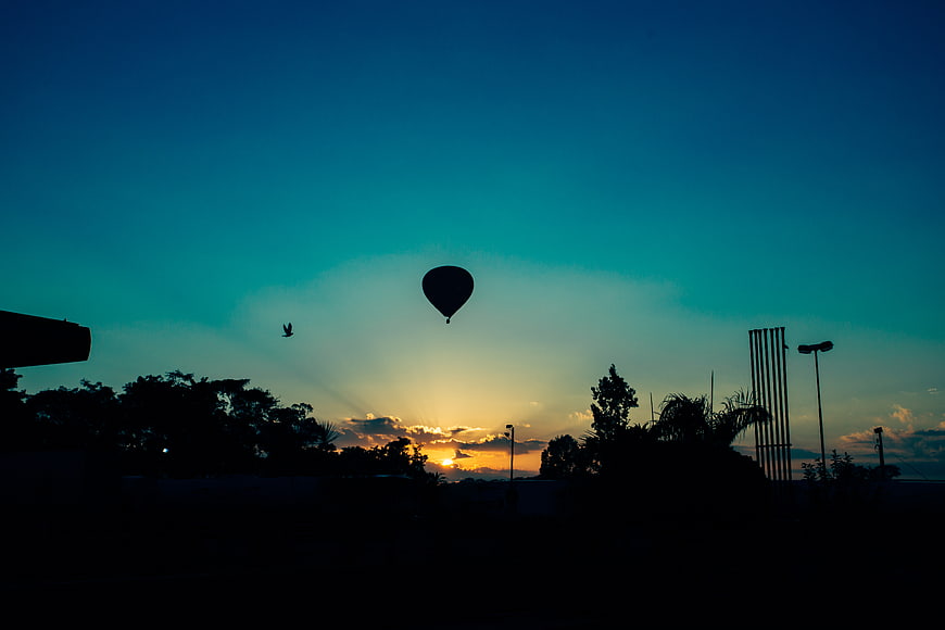 Silhouette of Hot Air Balloon Against Blue Sunset Sky