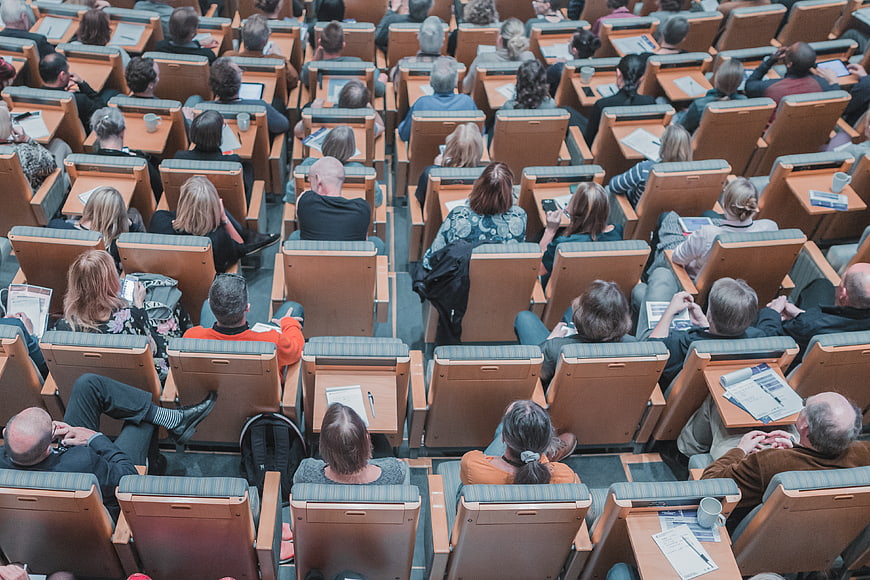 Audience in lecture hall from behind