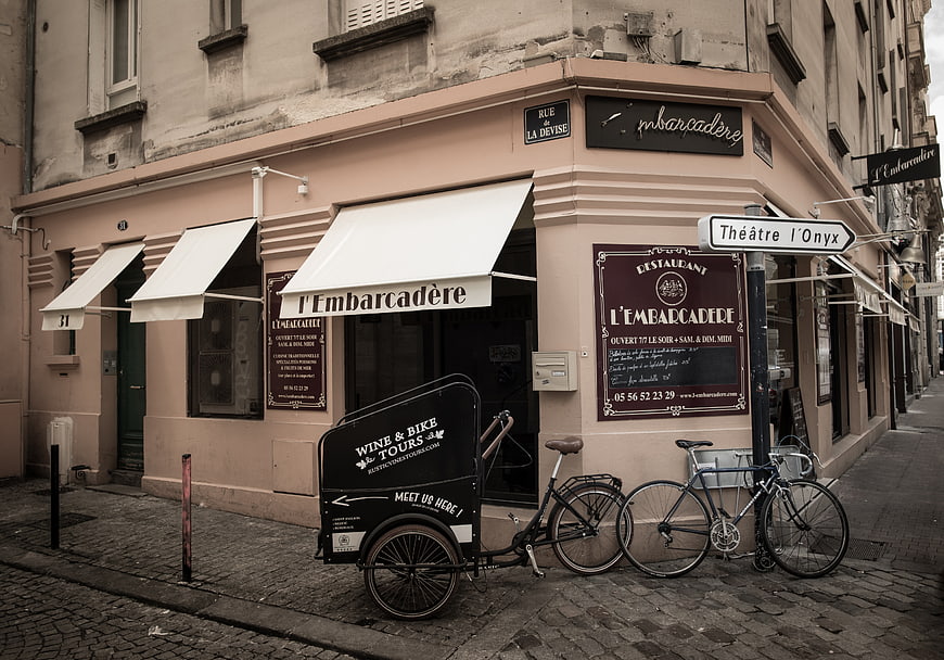 Cobblestone street corner with restaurant and cargo bike
