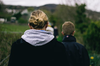Back view of woman and boy walking in nature