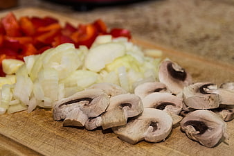 Sliced Mushrooms, Onions, and Peppers on Wooden Cutting Board