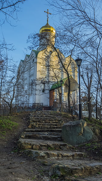 White Orthodox Church with Golden Dome on Stone Steps