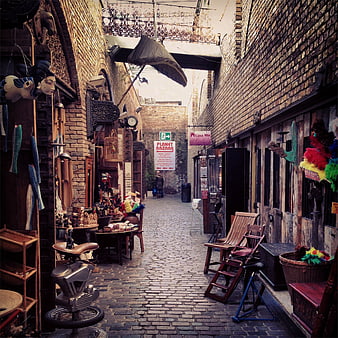 Narrow cobblestone alley in a vintage bazaar with eclectic shops