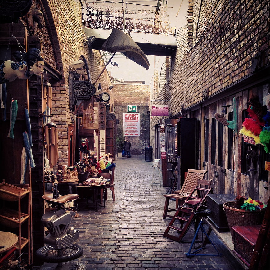 Narrow cobblestone alley in a vintage bazaar with eclectic shops