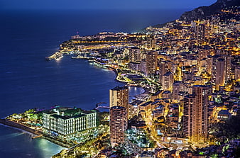 Aerial night view of Monaco cityscape and coastline