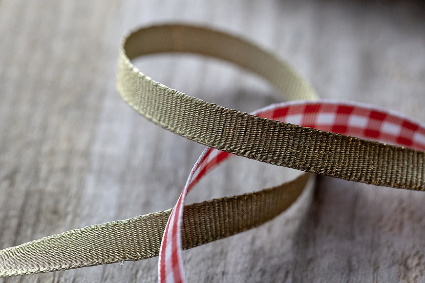 Gold and Red Gingham Ribbon on Wooden Background