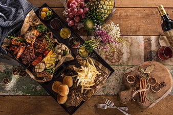 Overhead view of rustic BBQ feast with wine and spices