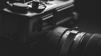 Close-up of vintage film camera lens in black and white