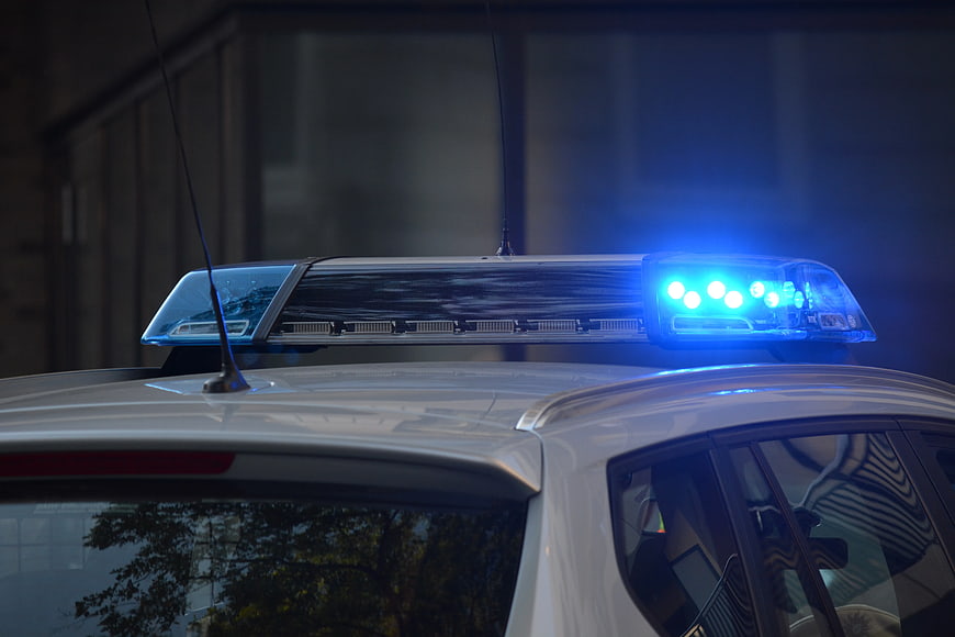 Close-up of police car blue emergency light bar at night