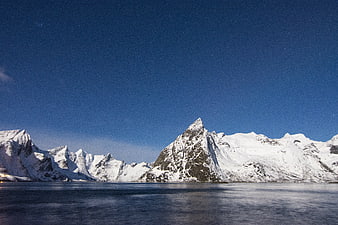 Snowy Mountains Under Starry Night Sky