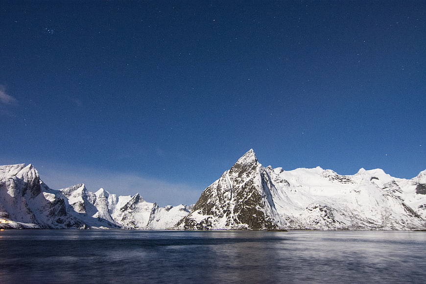 Snowy Mountains Under Starry Night Sky