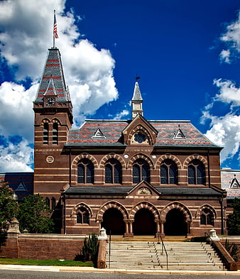 Historic Red Sandstone Church with Clock Tower and Blue Sky