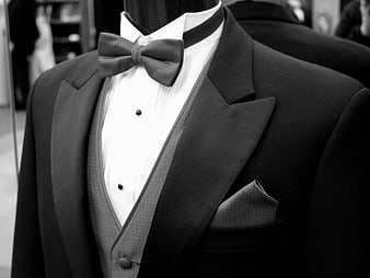 Black and white close-up of a formal tuxedo with bow tie and pocket square