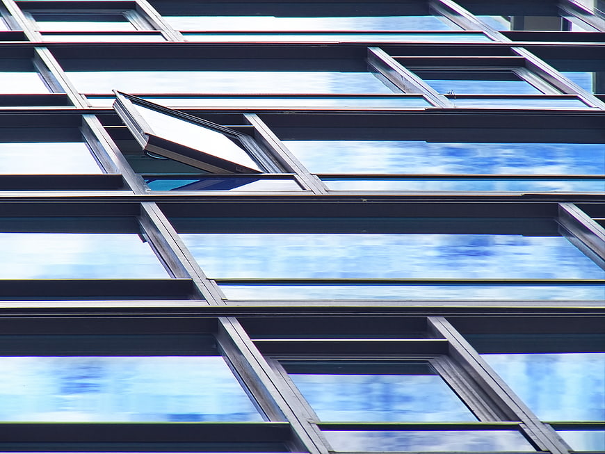 Modern Glass Building Facade with Open Window