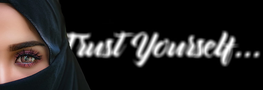 Close-up of woman in hijab with eye makeup and inspirational text