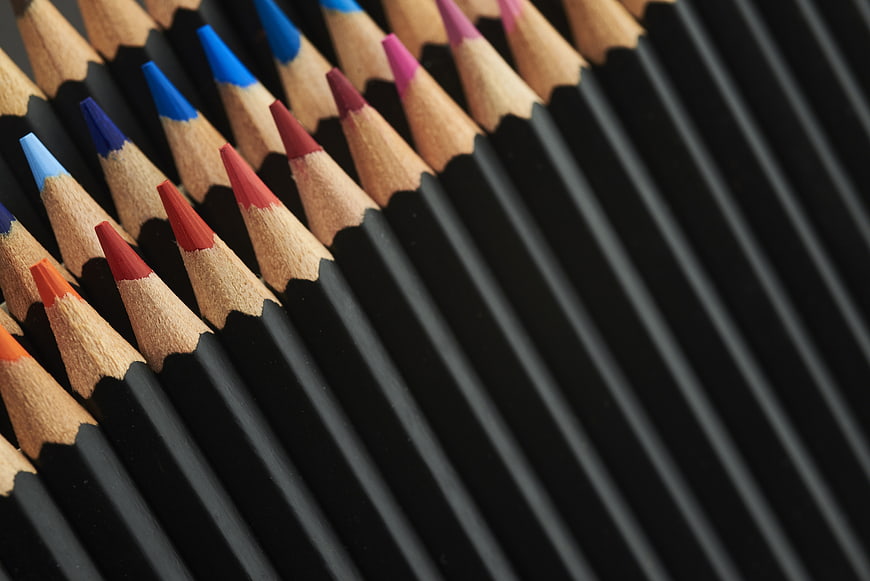Close-up of colorful pencils arranged in diagonal rows
