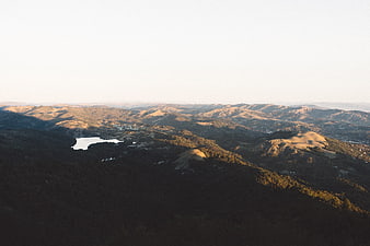 Aerial View of Golden Hills and Lake at Sunset