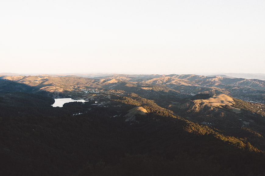 Aerial View of Golden Hills and Lake at Sunset