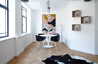 Modern dining room with herringbone floor and abstract art