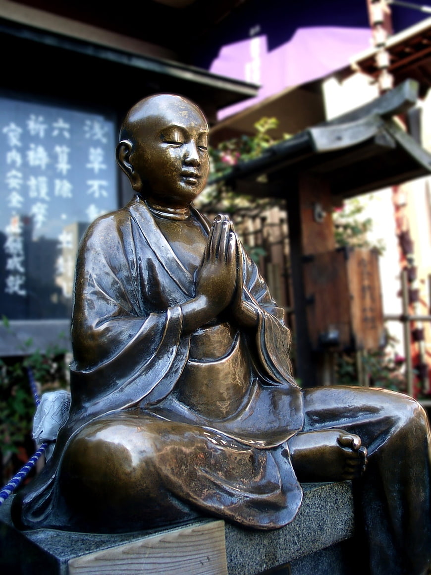 Bronze Statue of a Young Buddhist Monk in Prayer at a Japanese Temple