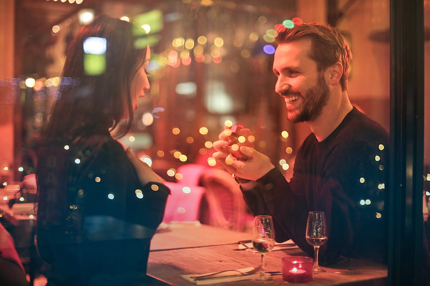 Romantic Marriage Proposal at Candlelit Restaurant