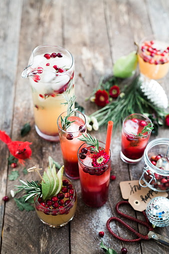 Festive Holiday Punch with Cranberries and Rosemary on Wooden Table