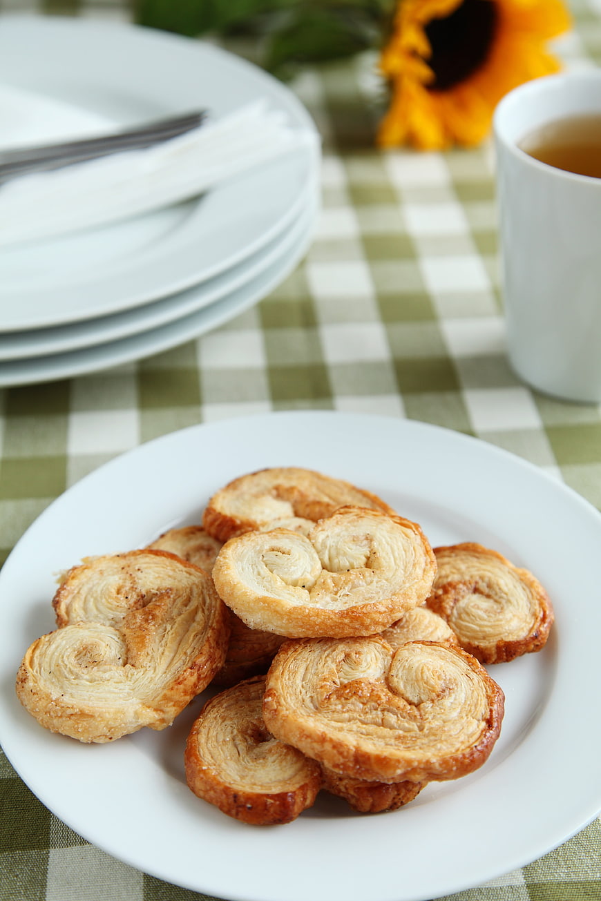 Golden Palmier Cookies on White Plate with Tea