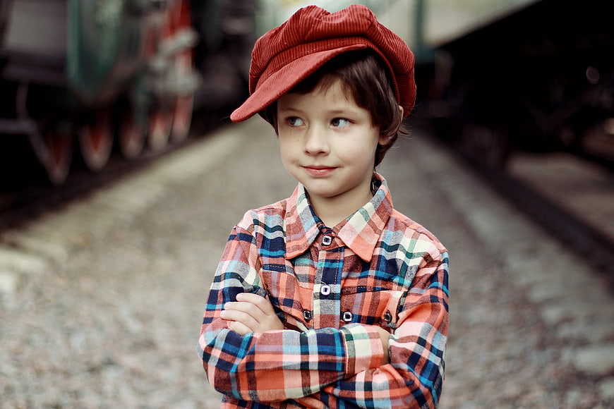 Portrait of a young boy in a red cap and plaid shirt
