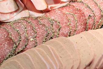 Close-up of sliced salami, ham, and liver paste cold cuts