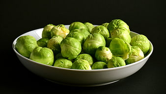 Fresh Brussels Sprouts In White Bowl On Black Background