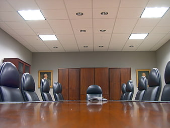 Empty corporate boardroom with leather chairs and wooden table