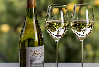 Bottle of White Wine and Two Glasses on Outdoor Table